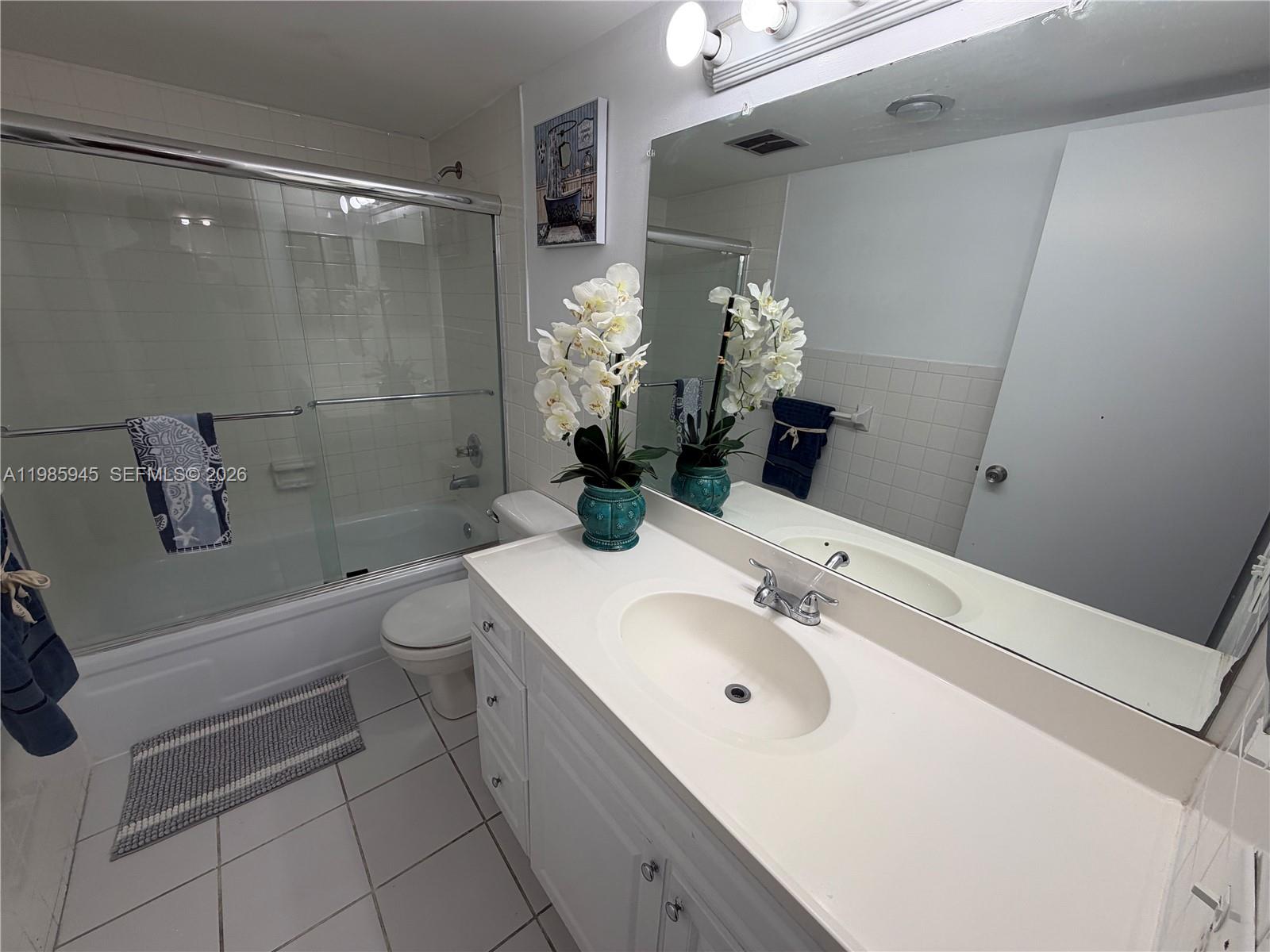 3962 Inverrary Drive, Unit A3 Lauderhill, FL 33319 - Photo 41 of 42 a bathroom with a sink a toilet and shower