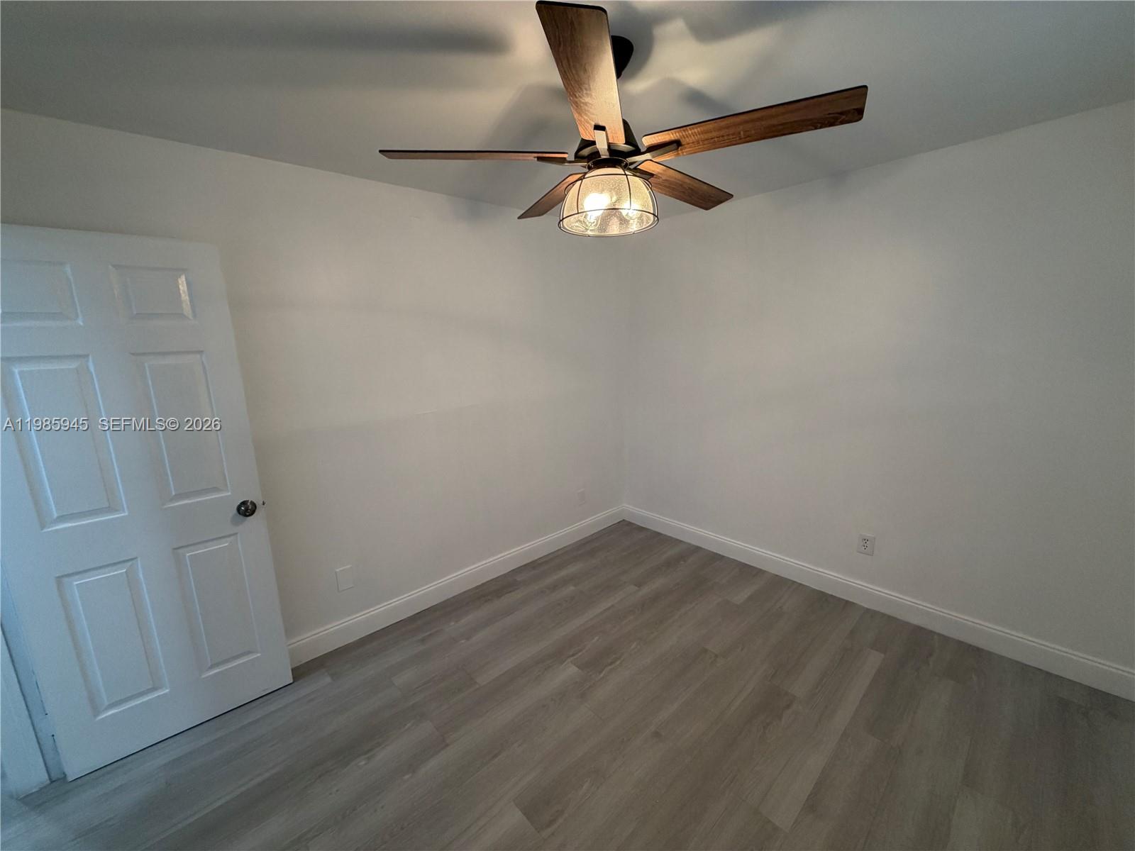 3962 Inverrary Drive, Unit A3 Lauderhill, FL 33319 - Photo 6 of 42 a view of a room with a hanging light and hardwood floor