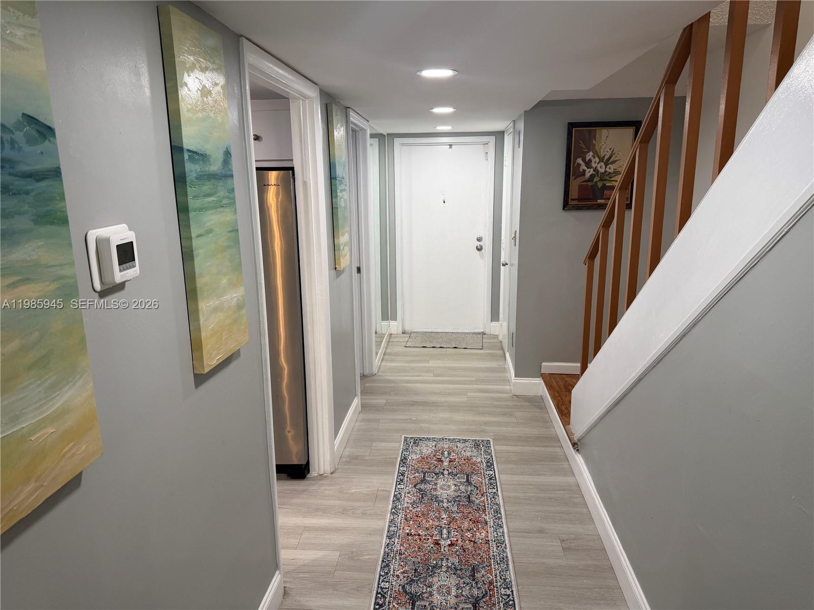 3962 Inverrary Drive, Unit A3 Lauderhill, FL 33319 - Photo 8 of 42 a view of a hallway with wooden floor and stairs