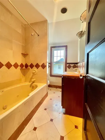 a living room with a bed furniture and a flat screen tv