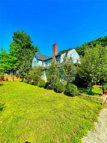 a view of a garden with a house in the background