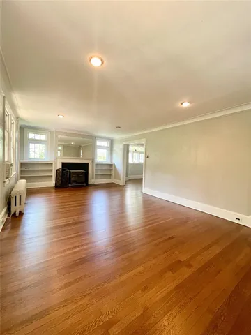 a view of living room with furniture and wooden floor