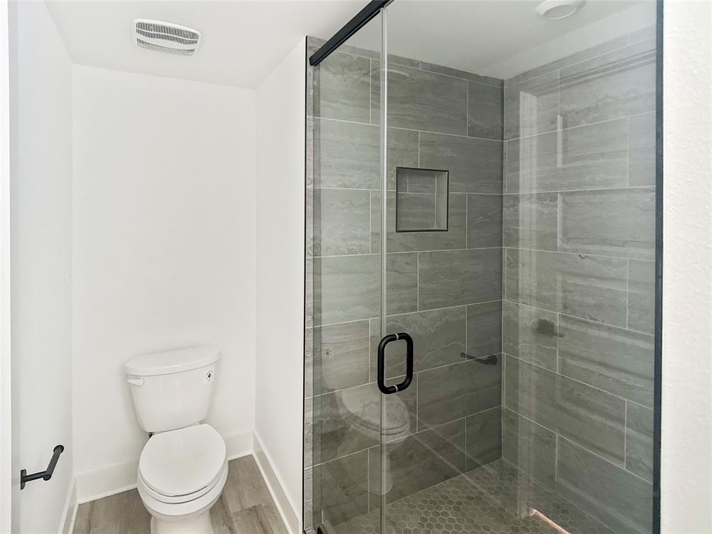 6107 Begonia Circle, Unit 2 Austin, TX 78741 - Photo 10 of 15 Full bathroom with wood finished floors and a stall shower