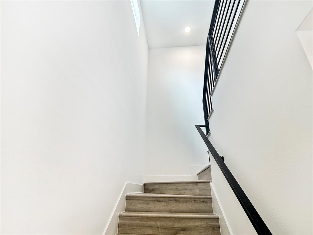 6107 Begonia Circle, Unit 2 Austin, TX 78741 - Photo 11 of 15 Stairs with baseboards and recessed lighting