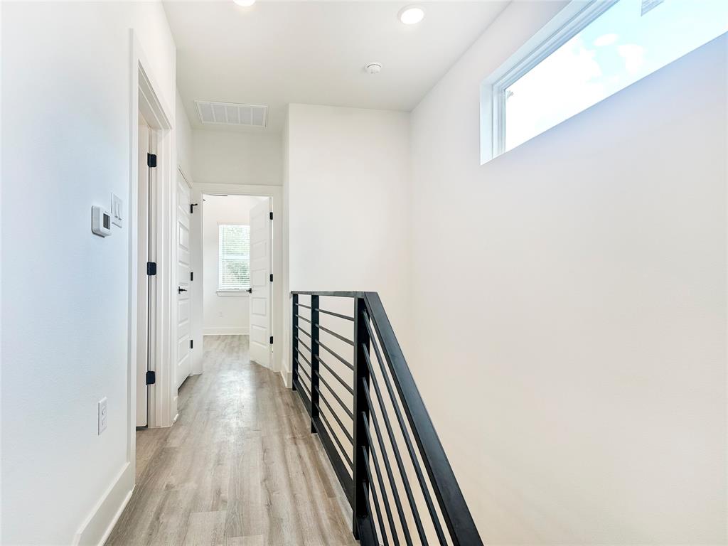 6107 Begonia Circle, Unit 2 Austin, TX 78741 - Photo 12 of 15 Hallway featuring an upstairs landing, light wood finished floors, and recessed lighting