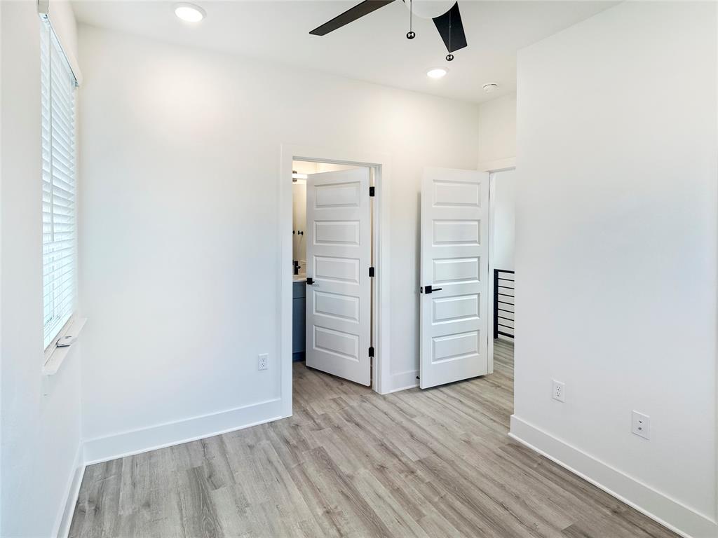6107 Begonia Circle, Unit 2 Austin, TX 78741 - Photo 13 of 15 Unfurnished bedroom featuring light wood-type flooring, ceiling fan, and recessed lighting