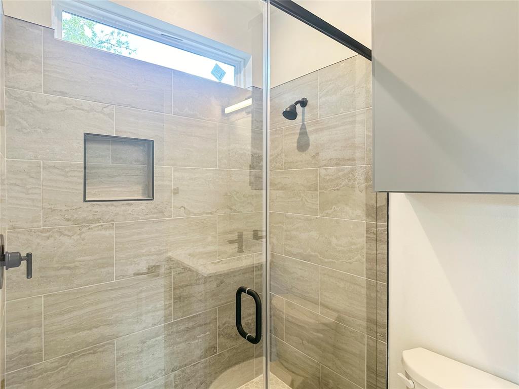 6107 Begonia Circle, Unit 2 Austin, TX 78741 - Photo 14 of 15 Full bath featuring a shower stall and toilet