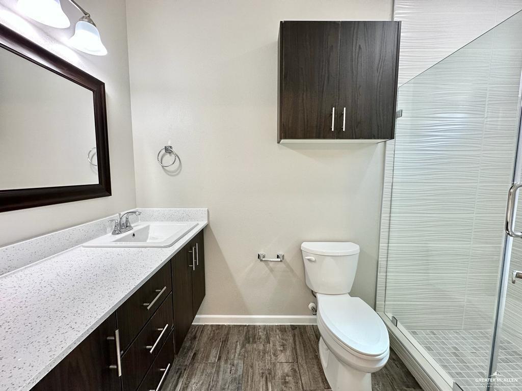 1002 Starr Street Mercedes, TX 78570 - Photo 10 of 17 a bathroom with a granite countertop toilet sink and mirror