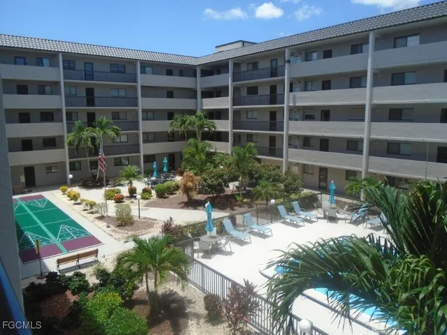 a view of swimming pool with outdoor seating and plants