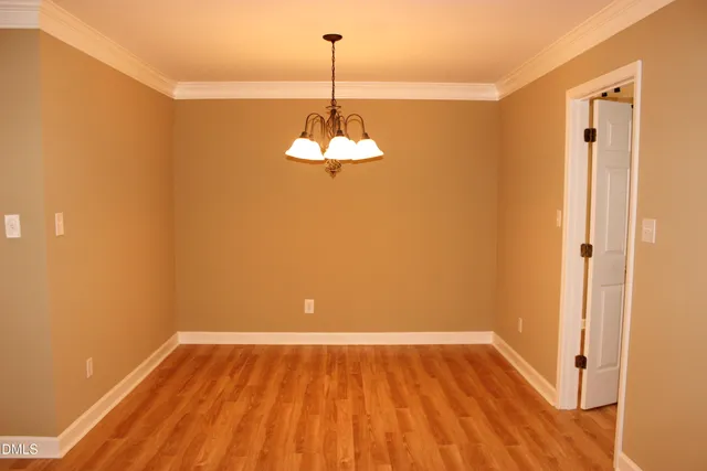 a view of a room with wooden floor and a window