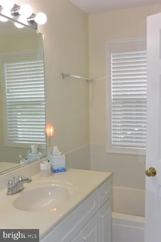 a bedroom with a bed and a mirror on dresser