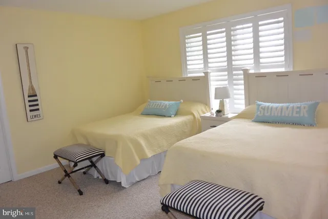 a bedroom with a bed chair and window