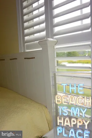 a bedroom with two beds and a window