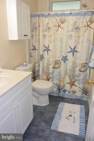 a view of a bedroom with furniture and a window