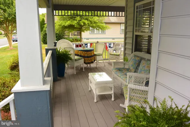 a balcony with table and chairs