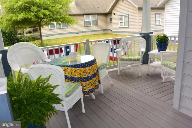 a view of outdoor dining space with a table and chairs