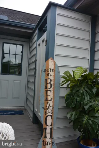 a vase of flowers sitting on a wooden floor