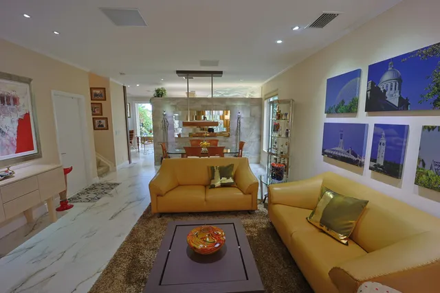 a living room with furniture a flat screen tv and a large window