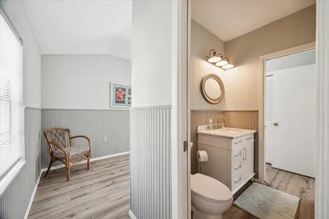 a view of bathroom with a toilet a sink and a mirror