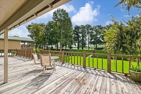 a view of balcony with wooden floor and lake view