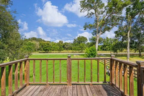 a view of balcony with yard and trees