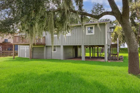 a view of a house with a yard and sitting area