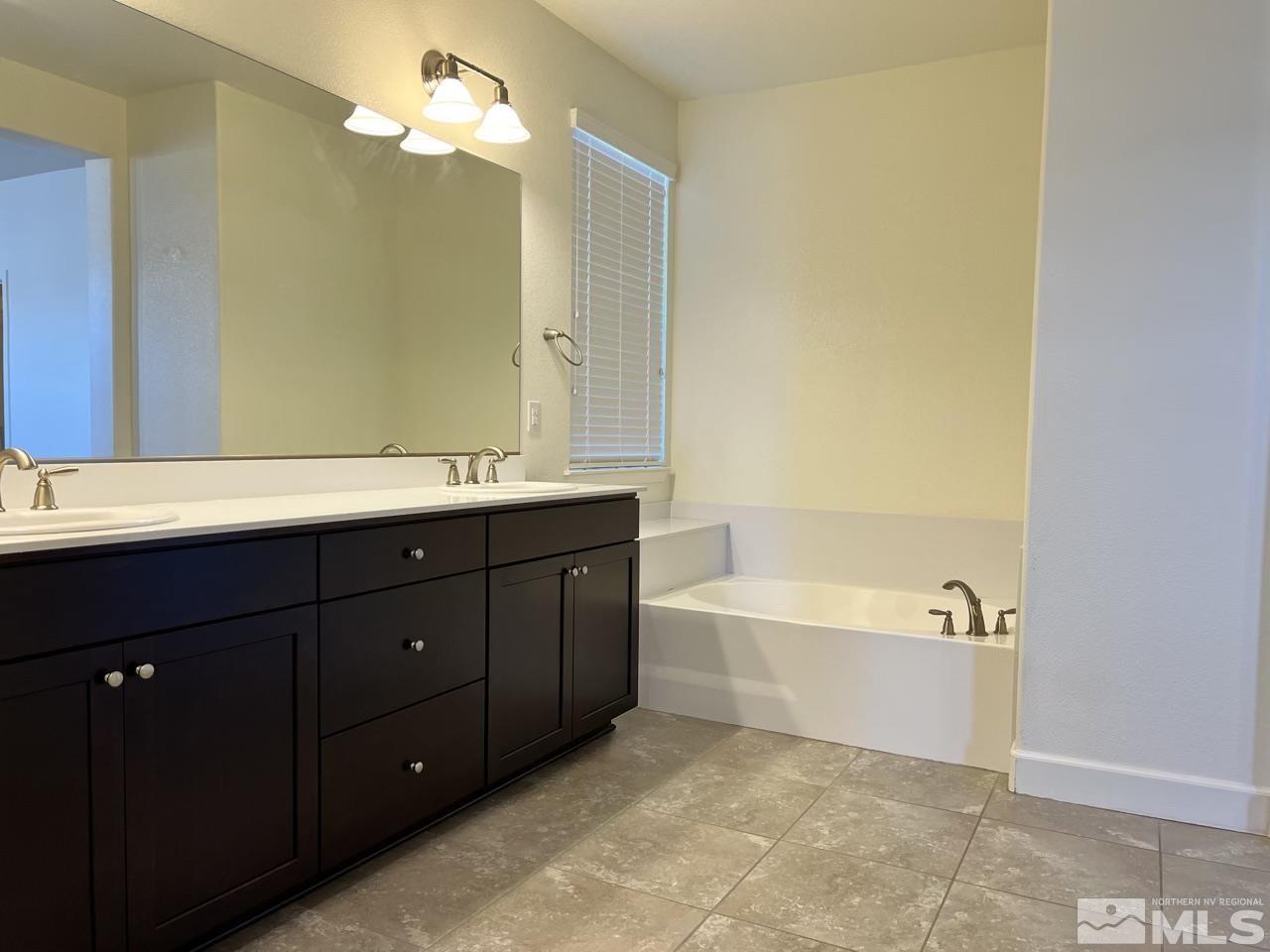 1765 Scott Valley Road Reno, NV 89523 - Photo 11 of 23 a bathroom with a tub sink and a mirror