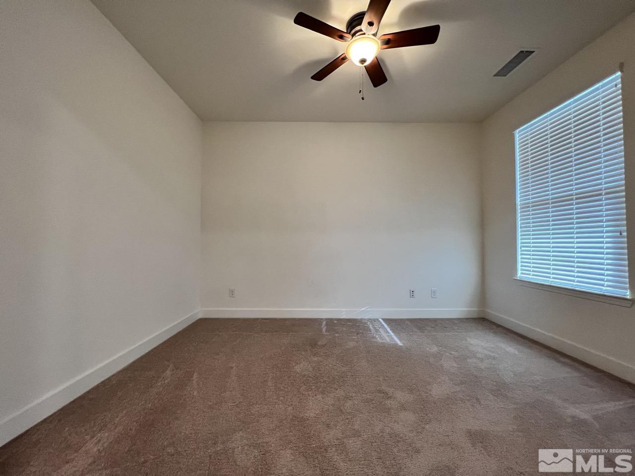 1765 Scott Valley Road Reno, NV 89523 - Photo 14 of 23 an empty room with a window and a fan
