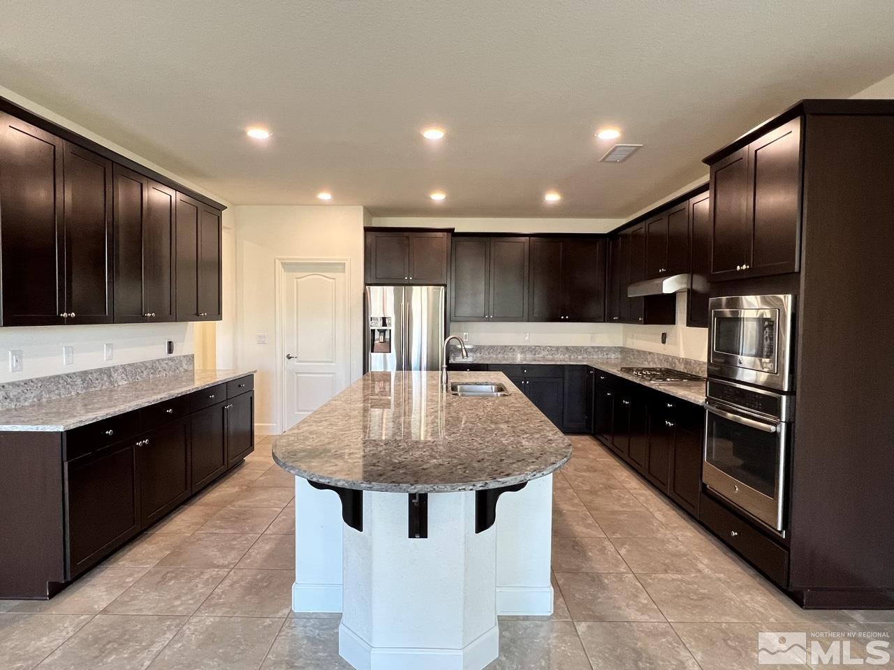 1765 Scott Valley Road Reno, NV 89523 - Photo 2 of 23 a kitchen with stainless steel appliances granite countertop a sink a stove and a refrigerator