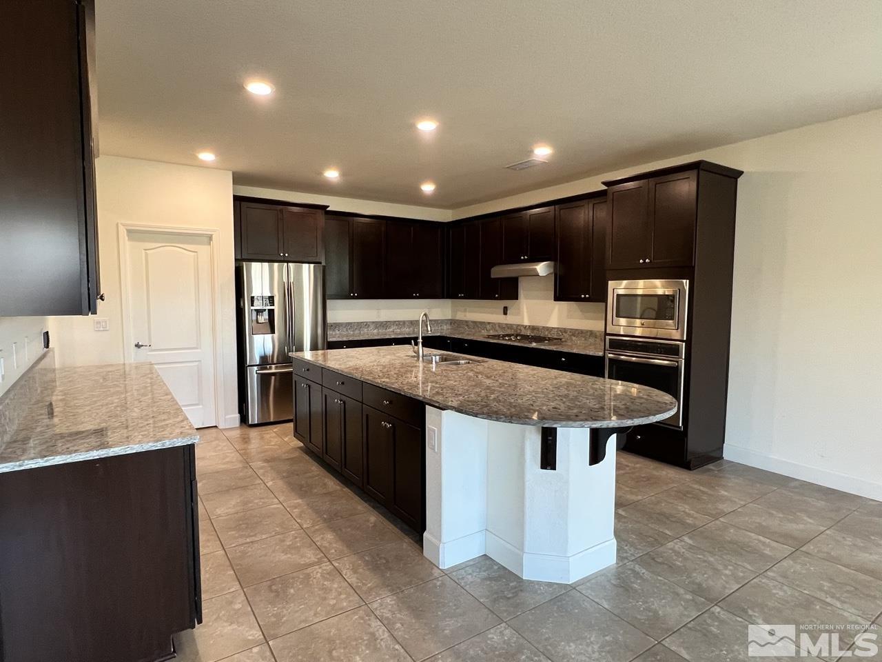 1765 Scott Valley Road Reno, NV 89523 - Photo 5 of 23 a large kitchen with stainless steel appliances a large counter top