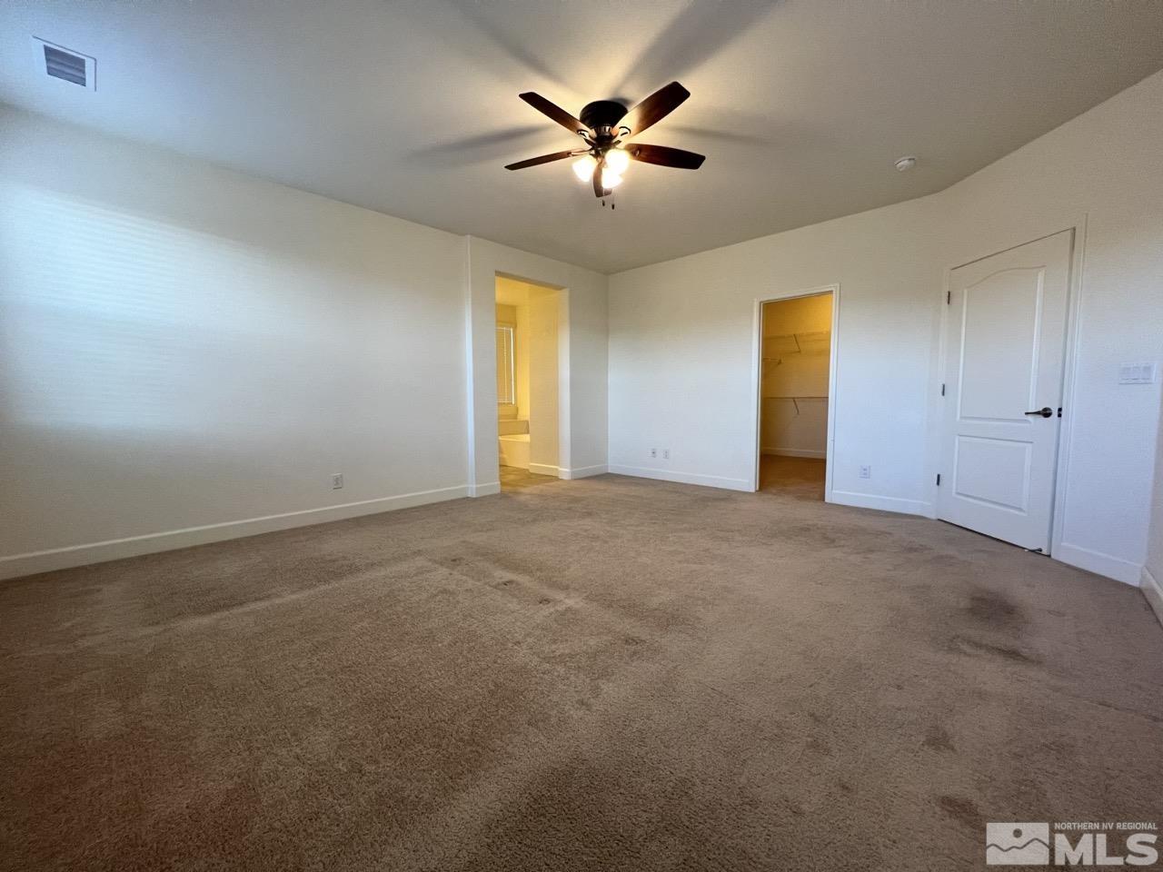 1765 Scott Valley Road Reno, NV 89523 - Photo 8 of 23 an empty room with a ceiling fan and window