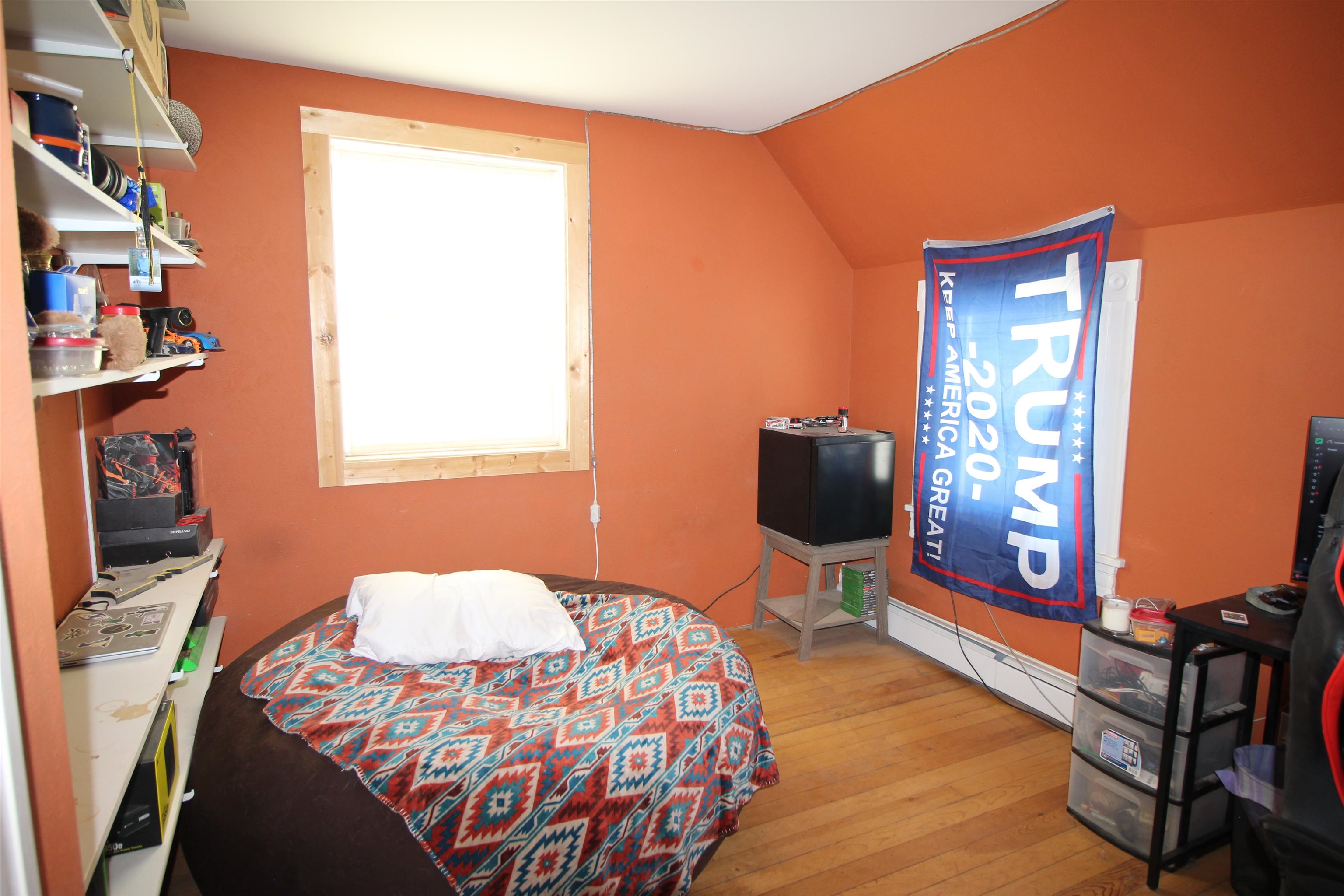 1150 East 7th Street Delta, CO 81416 - Photo 18 of 32 a bedroom with a bed and wooden floor