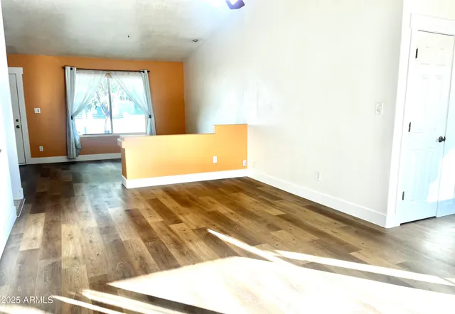 a view of a room with wooden floor