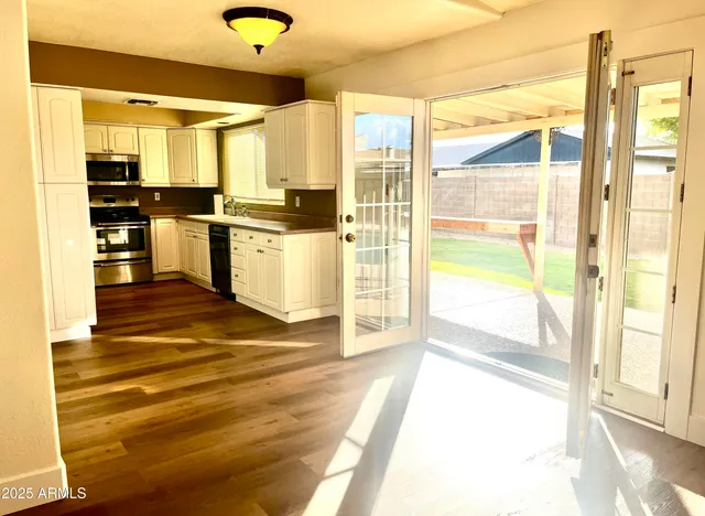 a kitchen with stainless steel appliances kitchen island granite countertop a refrigerator and a sink