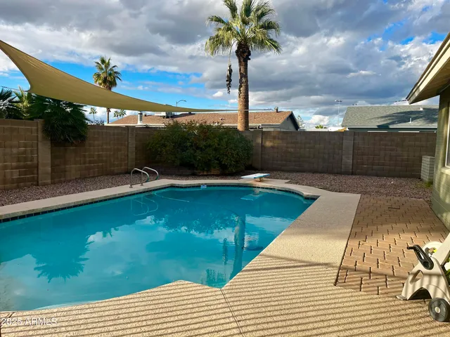 a picture of a swimming pool and outdoor seating
