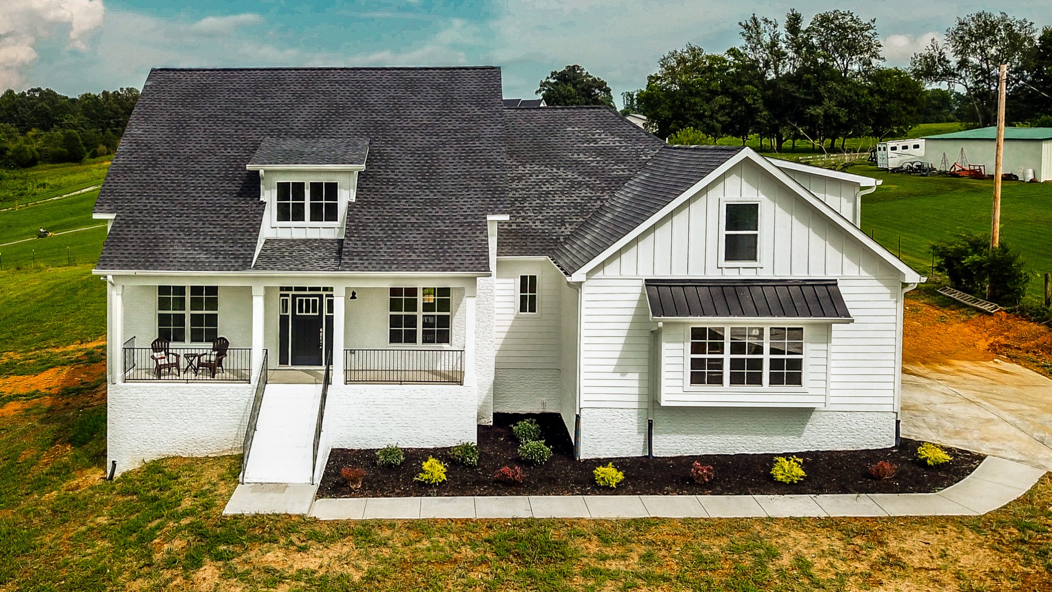 7866 Mill Road Cross Plains, TN 37049 - Photo 1 of 42 a front view of a house with a yard