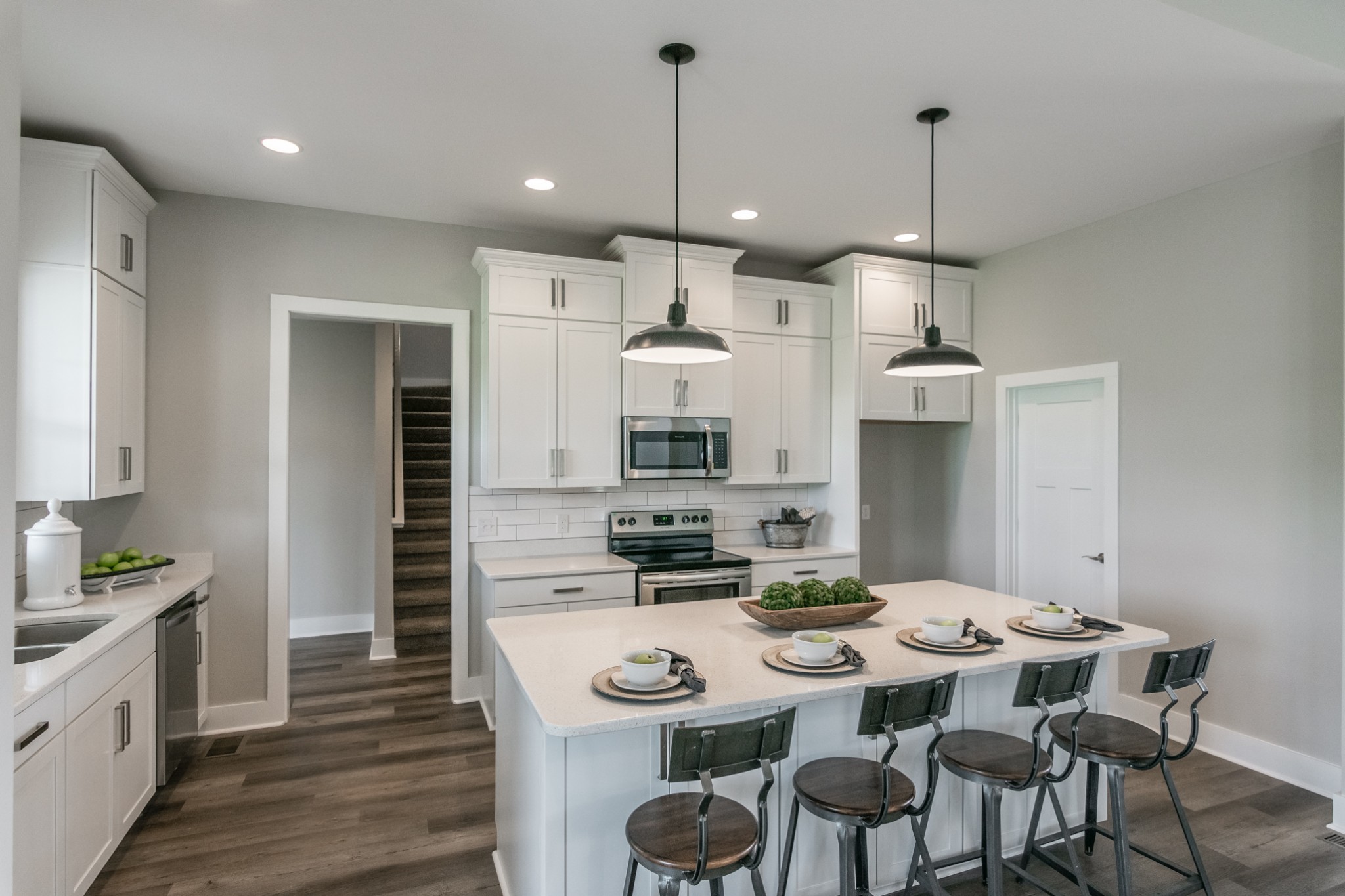 7866 Mill Road Cross Plains, TN 37049 - Photo 17 of 42 a kitchen with stainless steel appliances kitchen island granite countertop a stove a sink a dining table and chairs