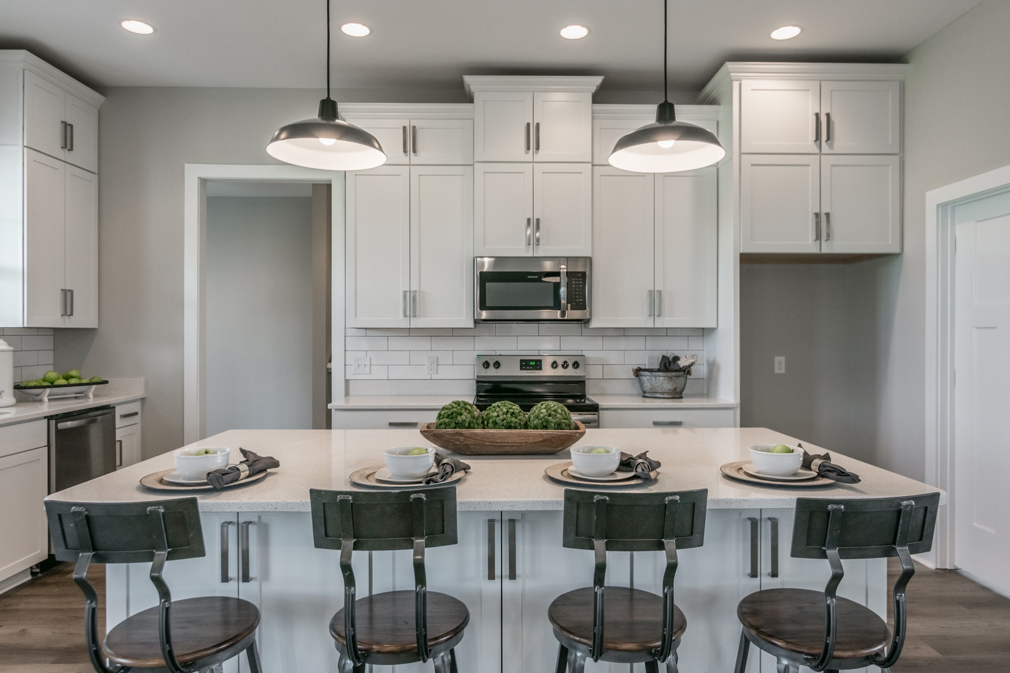 7866 Mill Road Cross Plains, TN 37049 - Photo 18 of 42 a kitchen with stainless steel appliances a table chairs stove and kitchen island
