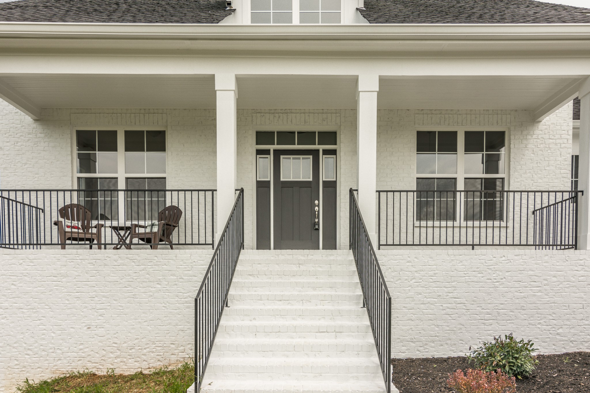 7866 Mill Road Cross Plains, TN 37049 - Photo 6 of 42 a view of a balcony with two chairs and a potted plant on a door
