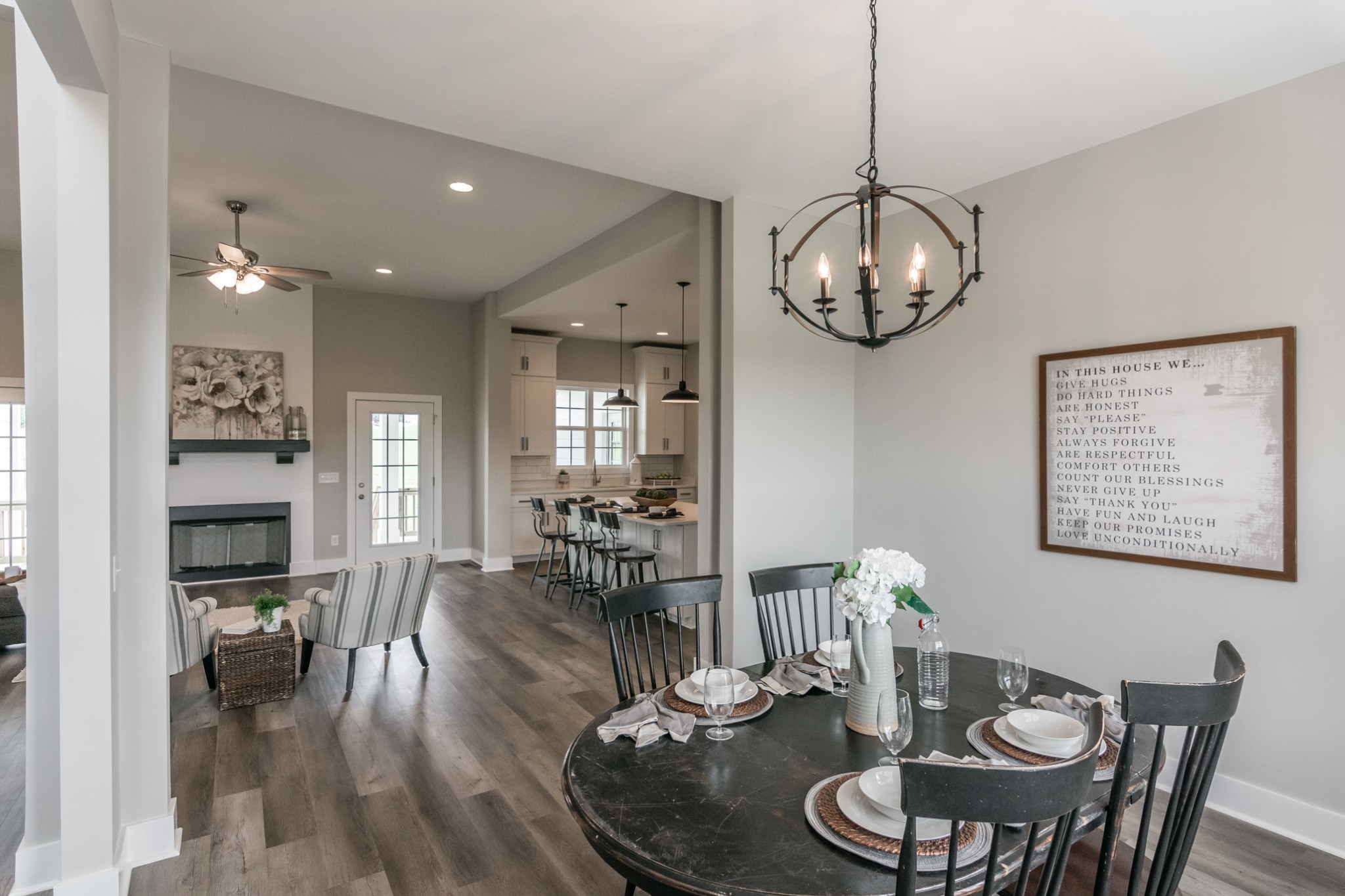 7866 Mill Road Cross Plains, TN 37049 - Photo 10 of 42 a dining room with wooden floor a chandelier a glass table and chairs