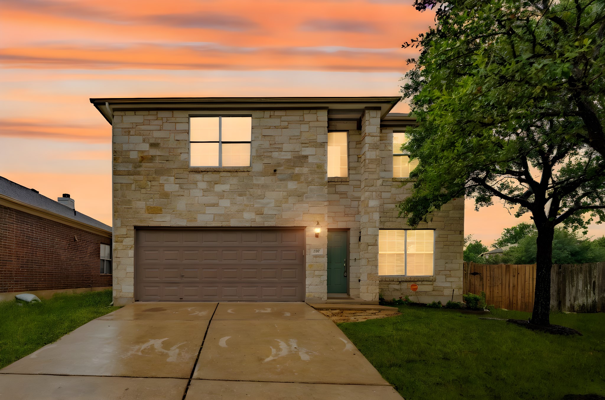 292 Housefinch Loop Leander, TX 78641 - Photo 1 of 1 View of front facade with a garage, driveway, and stone siding