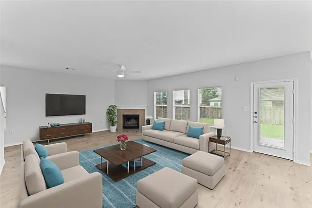 a living room with furniture wooden floor and a flat screen tv