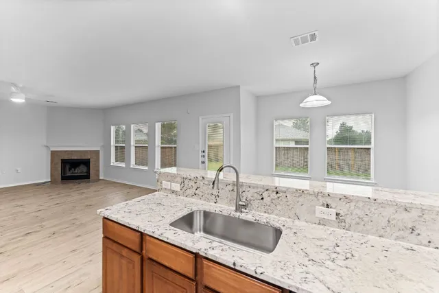 a kitchen with granite countertop a sink and a stove