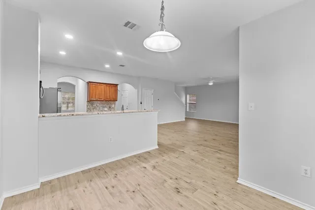 a view of a kitchen with wooden floor and a sink