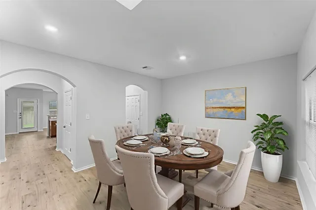 a view of a dining room with furniture and a potted plant