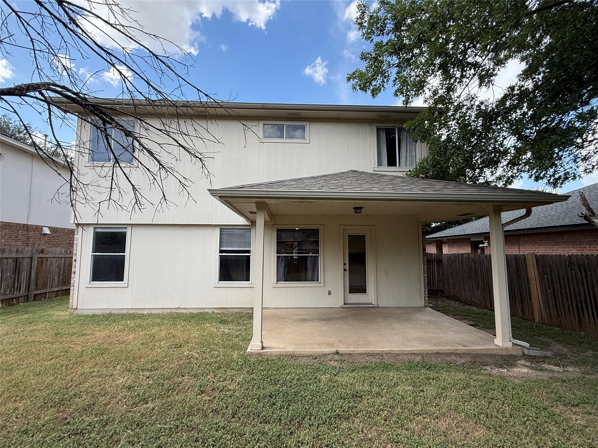 2120 Jester Farms Road Round Rock, TX 78664 - Photo 26 of 28 A well-maintained lawn embraces this two-story home, featuring a covered patio perfect for outdoor living.