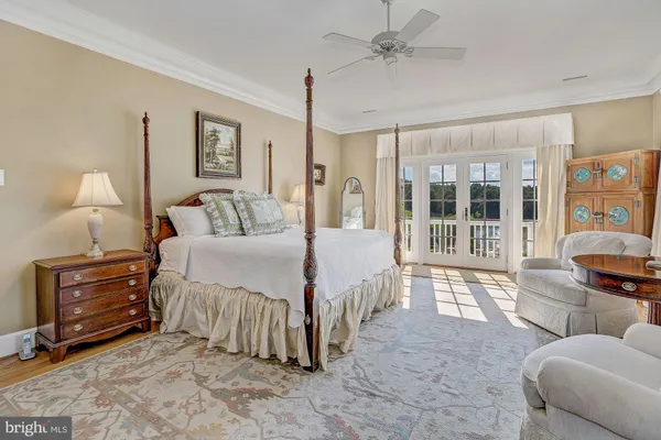 a spacious bedroom with a bed a couch and dresser