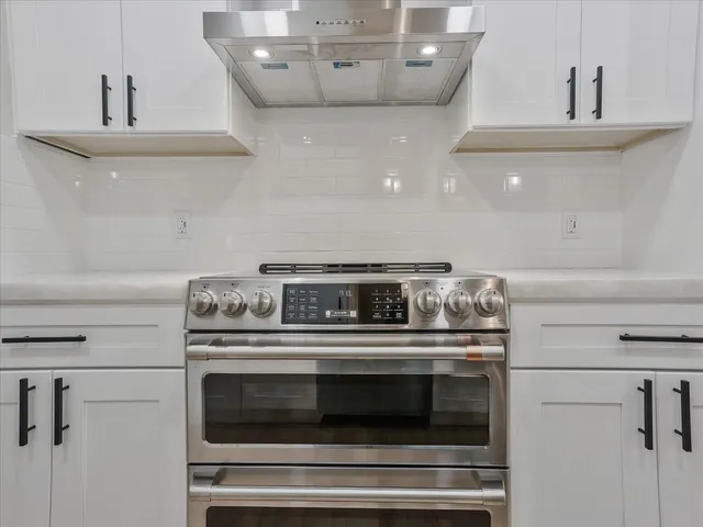 a stove top oven sitting inside of a kitchen