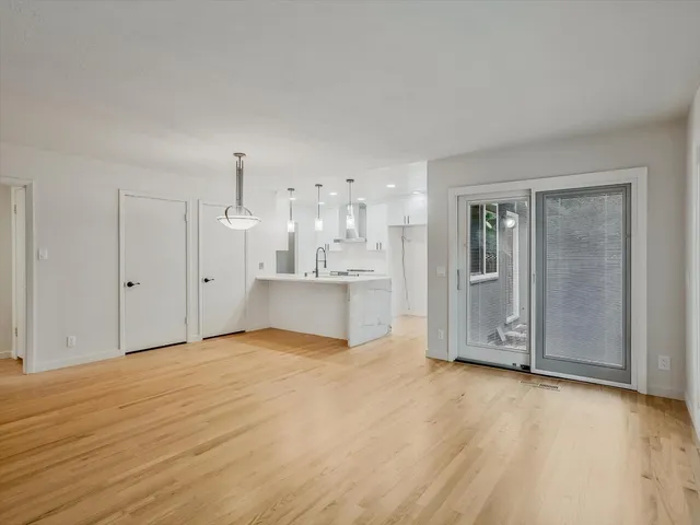 a view of a kitchen with wooden floor and a sink