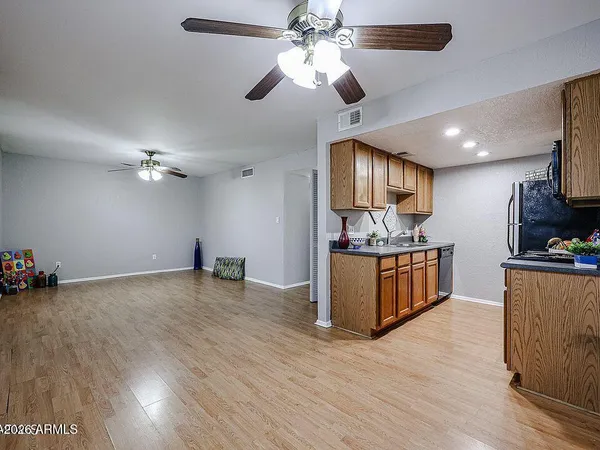 a view of kitchen with refrigerator microwave and stove